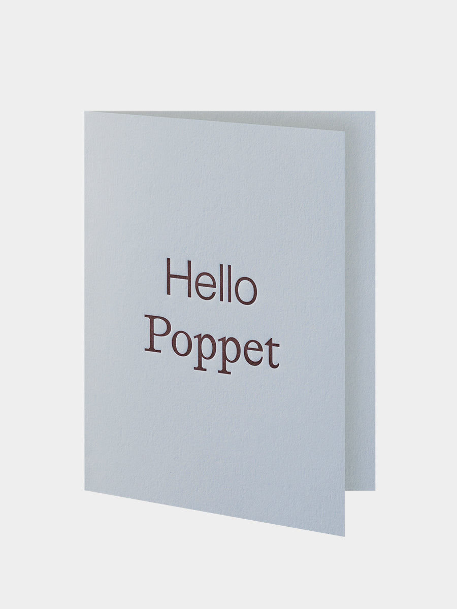 Light blue greeting card with 'Hello Poppet' text on a white background